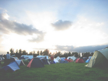 A number of tents pitched in a campinsite field
